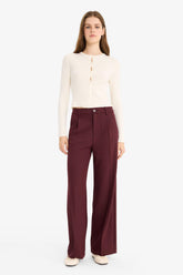 High-waisted, regular length trousers with three pockets and wide legs