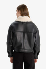 Oversize, loose-fitting faux leather jacket with faux fur lining and zipper closure.