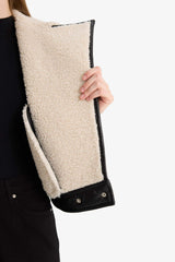 Oversize, loose-fitting faux leather jacket with faux fur lining and zipper closure.