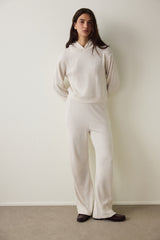 Off-white high-waisted trousers with knitted detail.