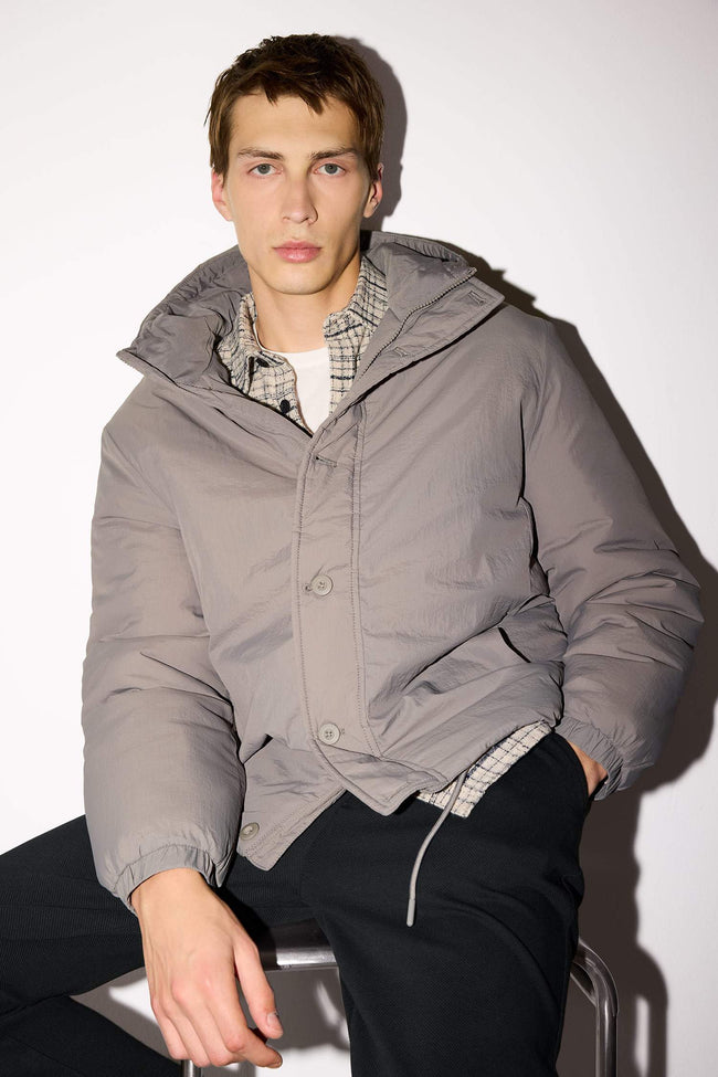 Water-repellent, regular-fit hooded jacket with zipper closure and interior pockets. Hover Image