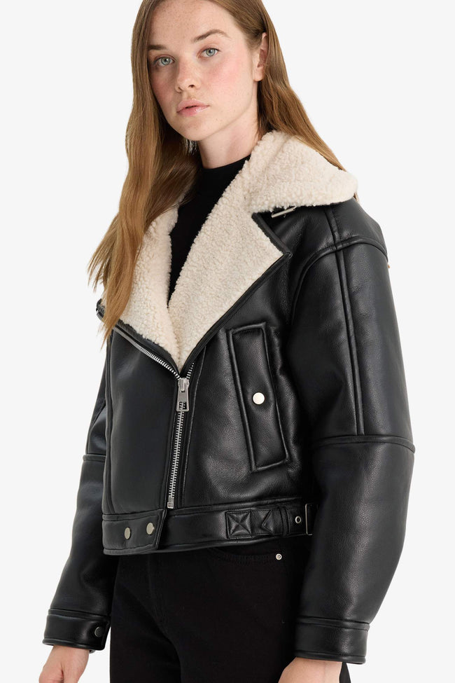 Oversize, loose-fitting faux leather jacket with faux fur lining and zipper closure. Hover Image