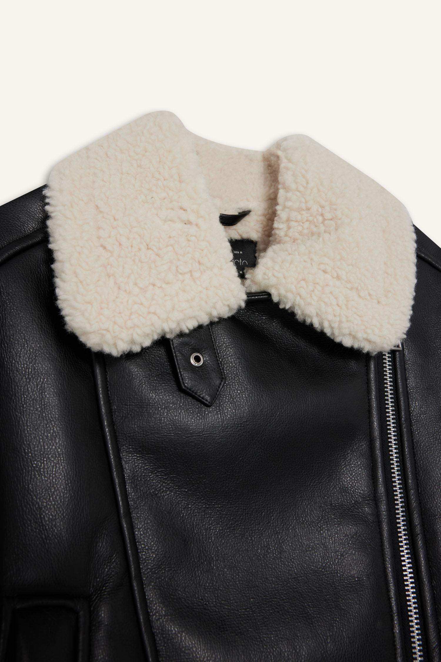 Oversize, loose-fitting faux leather jacket with faux fur lining and zipper closure.