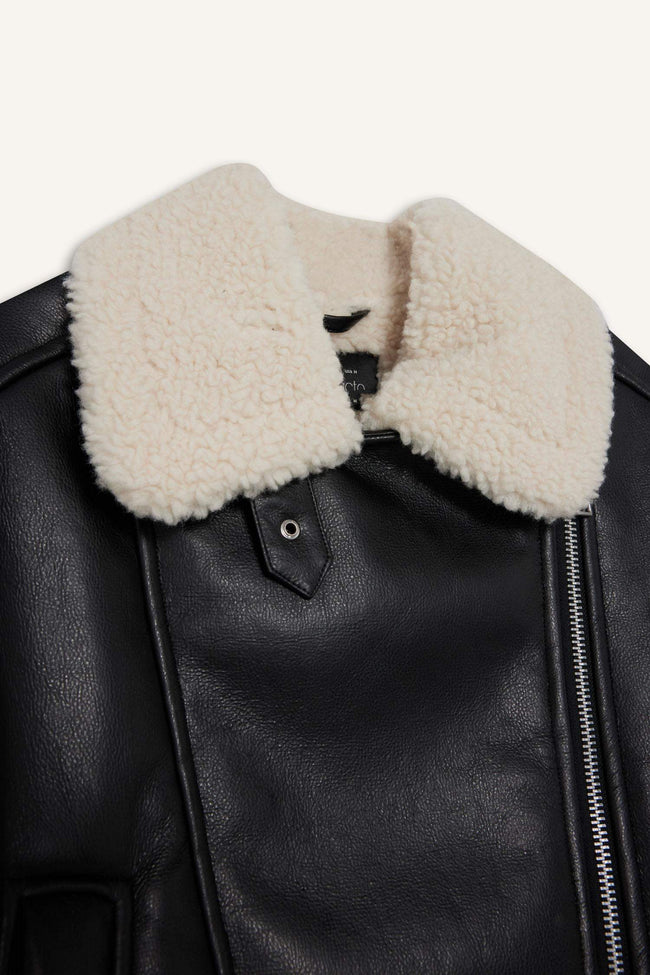 Oversize, loose-fitting faux leather jacket with faux fur lining and zipper closure. Main Image