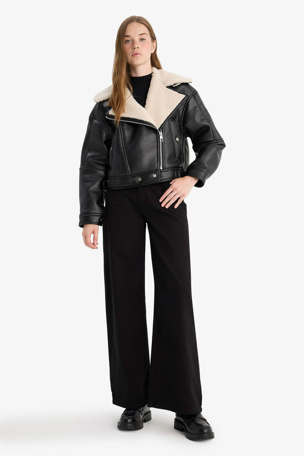 Oversize, loose-fitting faux leather jacket with faux fur lining and zipper closure.