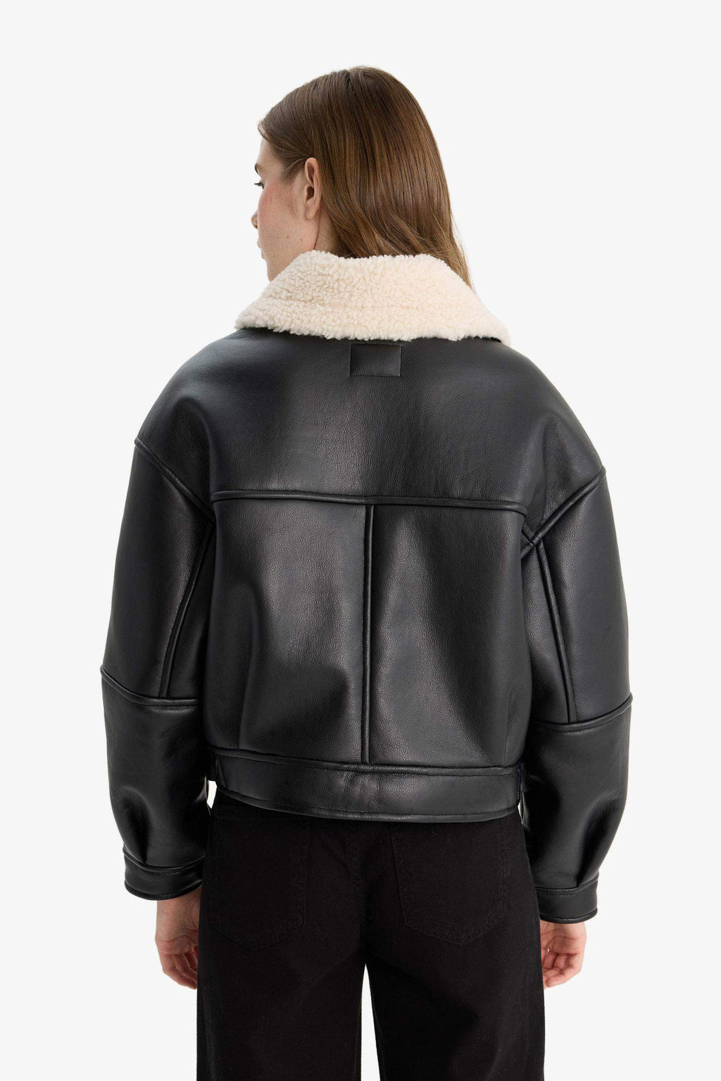 Oversize, loose-fitting faux leather jacket with faux fur lining and zipper closure.