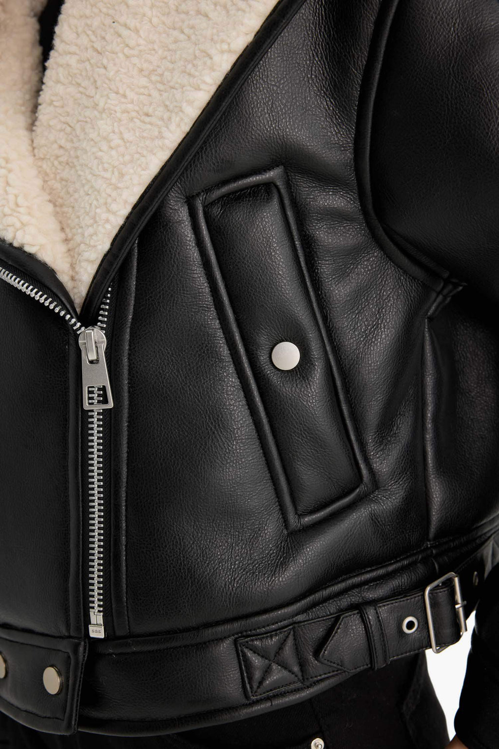 Oversize, loose-fitting faux leather jacket with faux fur lining and zipper closure.