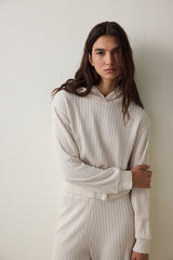 Off-white hooded sweatshirt with knitted detail.