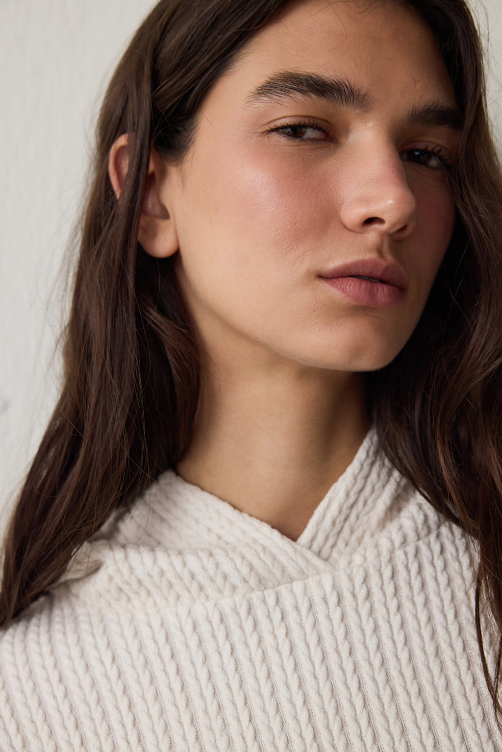 Off-white hooded sweatshirt with knitted detail.