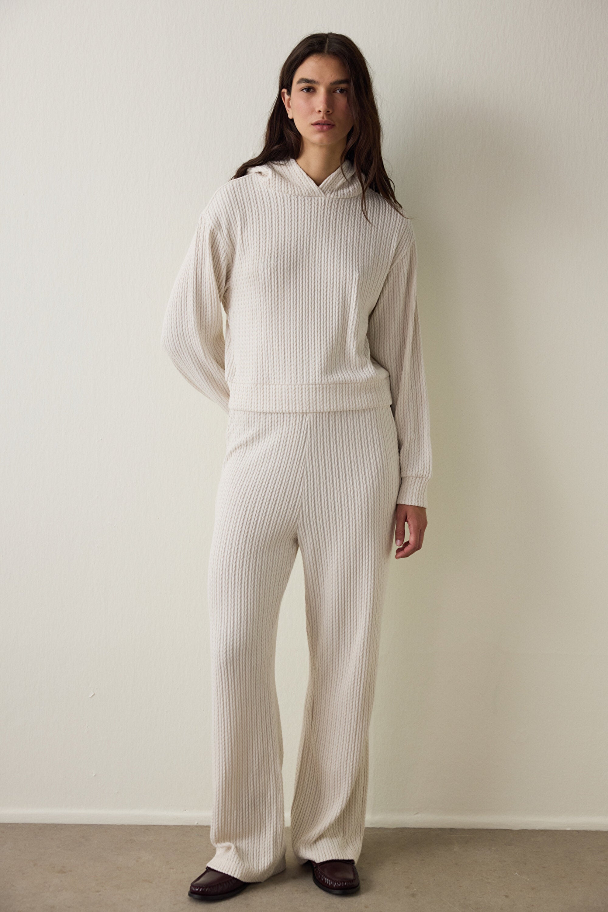 Off-white hooded sweatshirt with knitted detail.