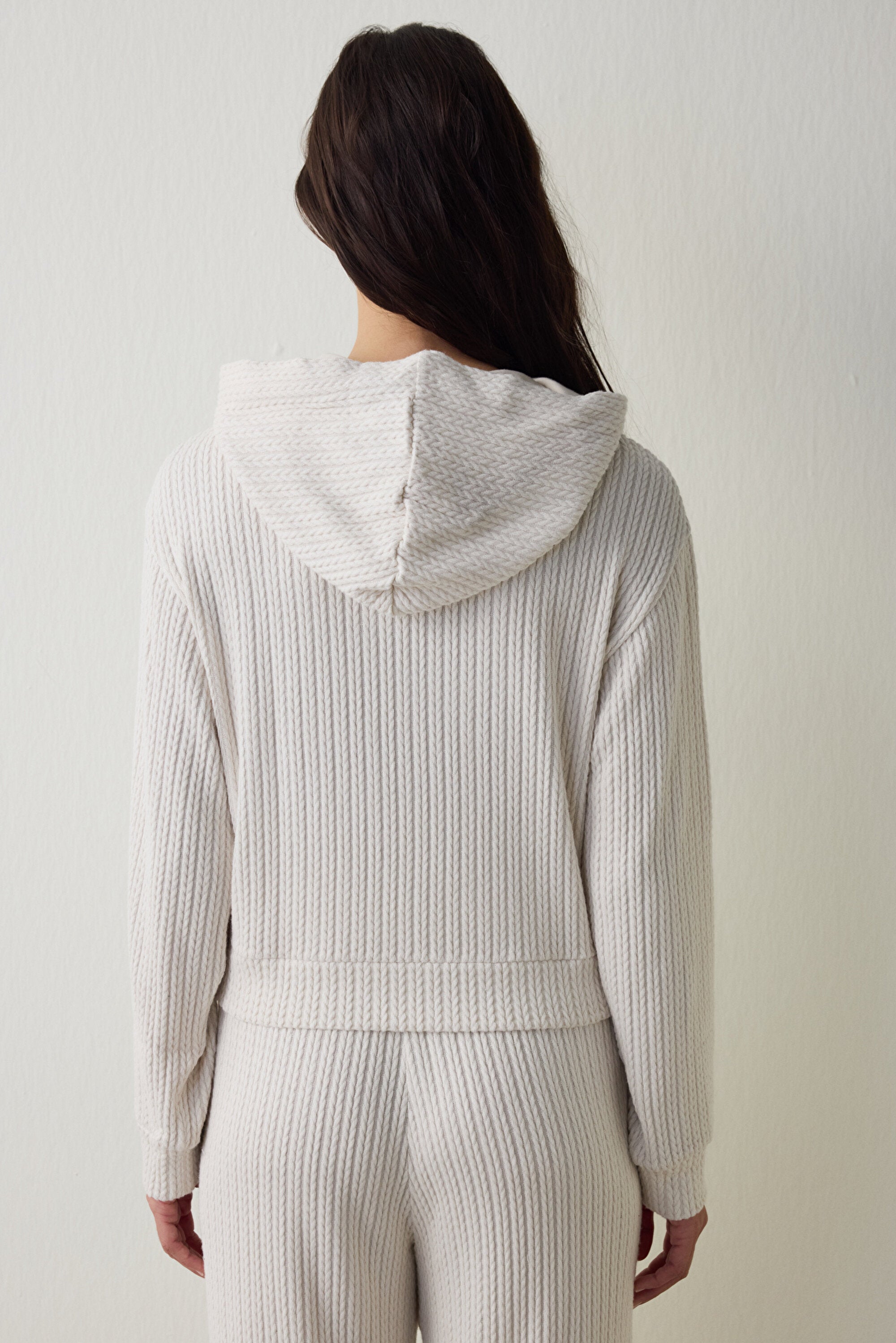 Off-white hooded sweatshirt with knitted detail.