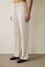 Off-white high-waisted trousers with knitted detail.