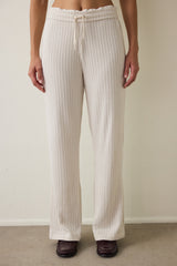 Off-white high-waisted trousers with knitted detail.